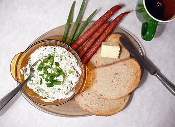 Polish breakfast with curd cheese mixed with chives and Polish kabanos sausages