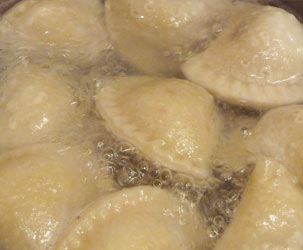 Boiling pierogi in a salted water