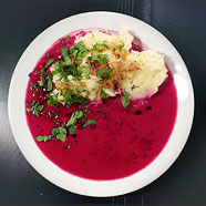 Photo of red borscht with cream and potato